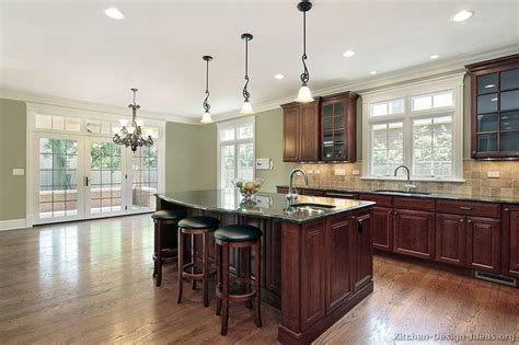 Partner these classic cabinets with white walls, marble countertops, and ebony hardwood floors for a. Pictures of Kitchens - Traditional - Dark Wood Kitchens ...