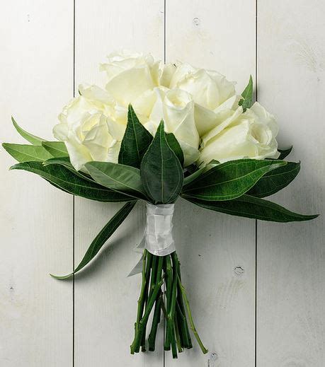 A step by step tutorial on. Simple wedding bouquet with rose white and green leaves.JPG