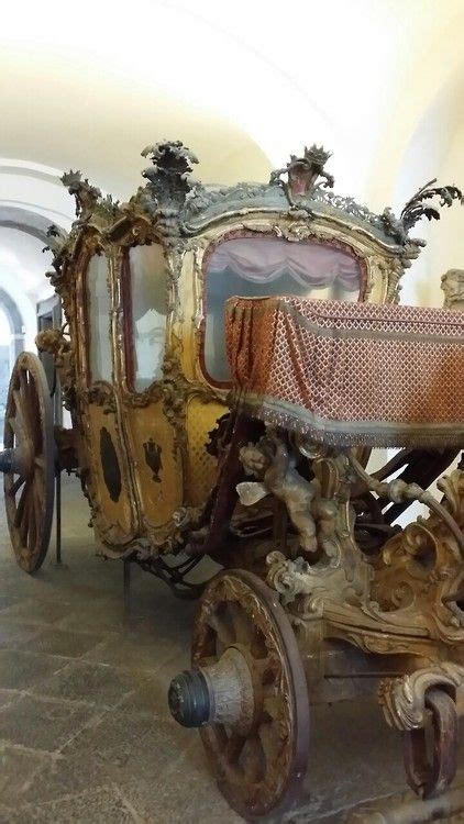 An Old Fashioned Carriage Is On Display In A Museum