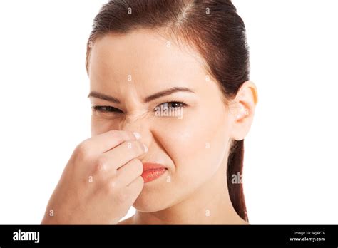 Portrait Of A Young Woman Holding Her Nose Because Of A Bad Smell