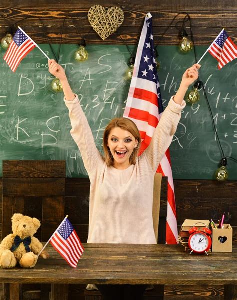 Patriotism And Freedom Woman In Classroom With American Flag At