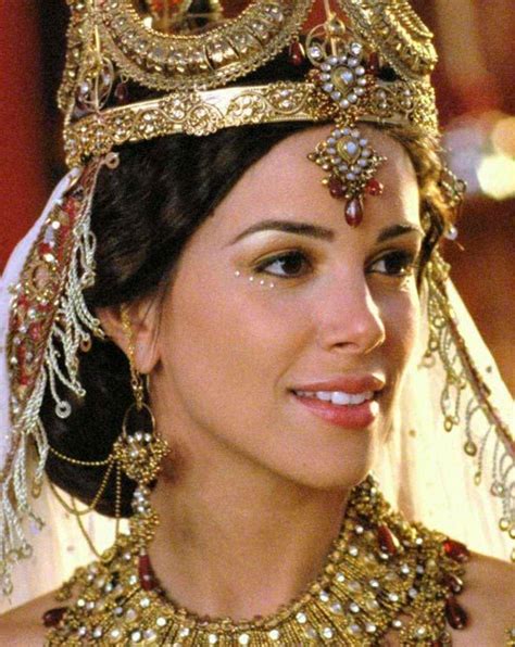 A Woman Wearing A Tiara And Gold Jewelry