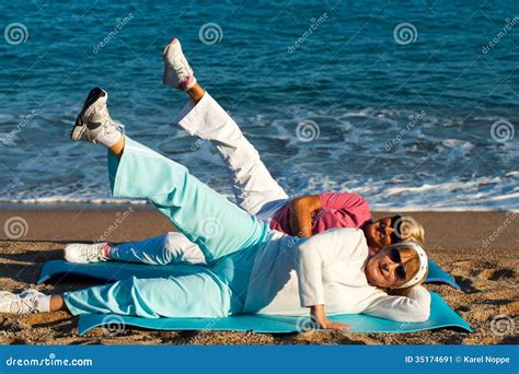 Senior Women Stretching Legs On Beach Stock Image Image 35174691
