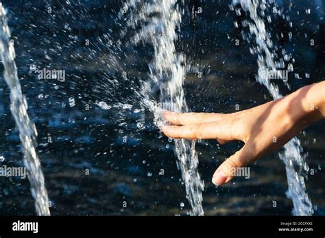Hand Of A Girl In A Spray Of Water From A Fountain Stock Photo Alamy