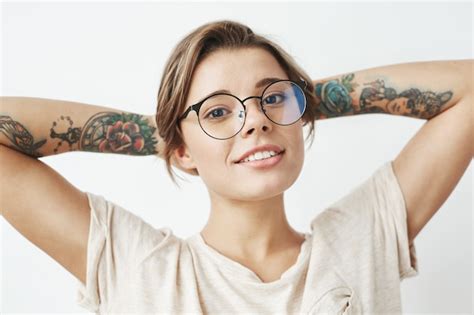 Free Photo Portrait Of Beautiful Young Tattooed Girl In Glasses Smiling
