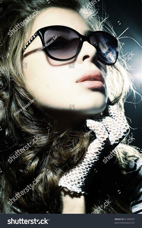 Fashion Portrait Of A Beautiful Young Sexy Woman Wearing Sunglasses