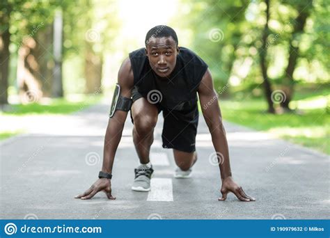 Black Man Jogger In Ready Position Training At Park Stock Photo