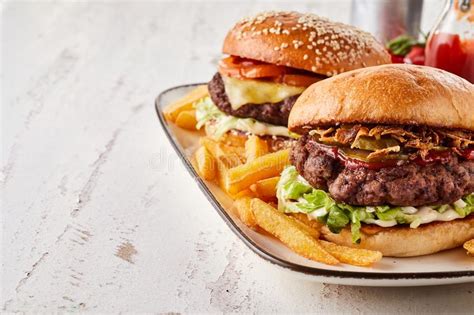 Two Tasty Hamburgers Served With French Fries Stock Photo Image Of