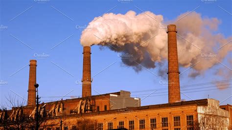 Factory Plant Smoke Stack Over Blue Sky Background Containing Smoke