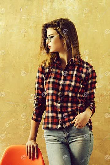 Pretty Girl In Glasses Wearing Red Plaid Shirt And Jeans Stock Image