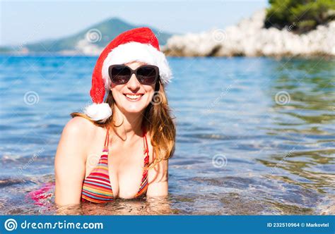 Woman In Bikini And In Santa Hat On The Sea Christmas Vacation Close