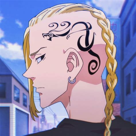 A Man With Long Blonde Hair Has A Tattoo On His Head And Is Looking Off