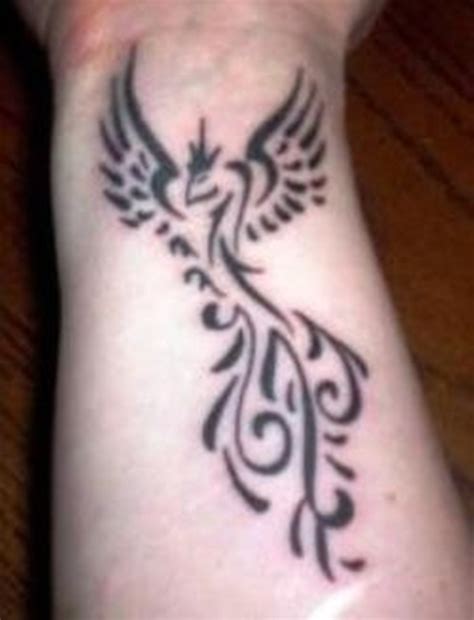 The black lined tattoo has some simple grey shading and stands out from generic tattoos on the wrist. 8 Phoenix Wrist Tattoos Designs