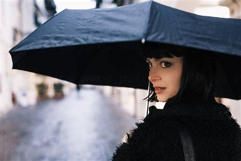 woman walking outdoor during a rainy day by stocksy contributor mauro grigollo stocksy