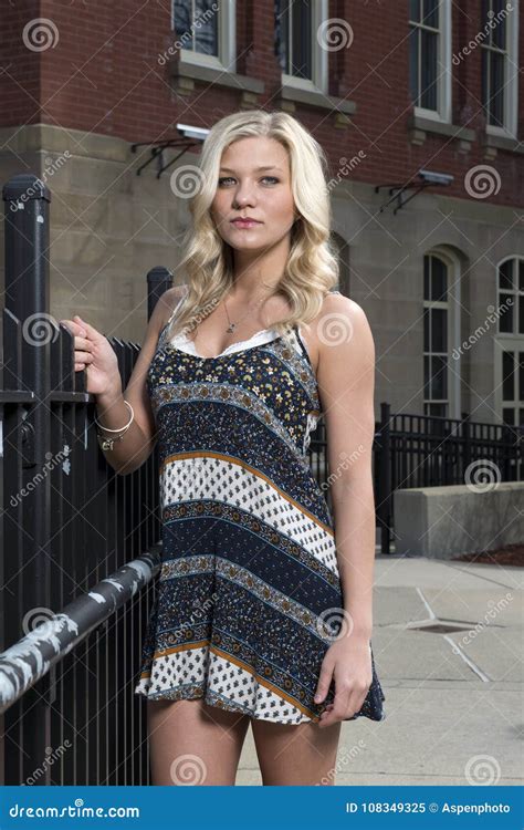 Adorable Young Blonde College Student On Campus In Romper Or Sundress