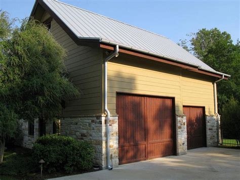 A Garage With A Metal Roof And Brown Doors