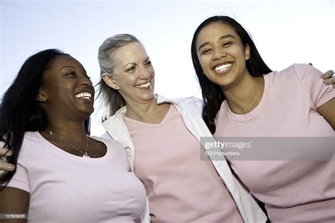 Happy Diverse Group Of Women Laughing Together In Pink Shirts High Res