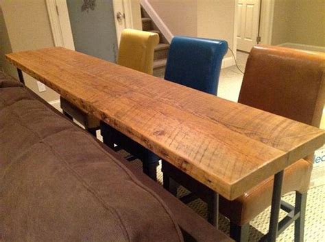 In essence, a sofa bar table is a tall, narrow table that matches the height of the back of the sofa with bar stools tucked beneath. bar table behind sofa