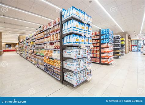 Lanes Of Shelves With Aisle Of Goods Products Inside A Supermarket