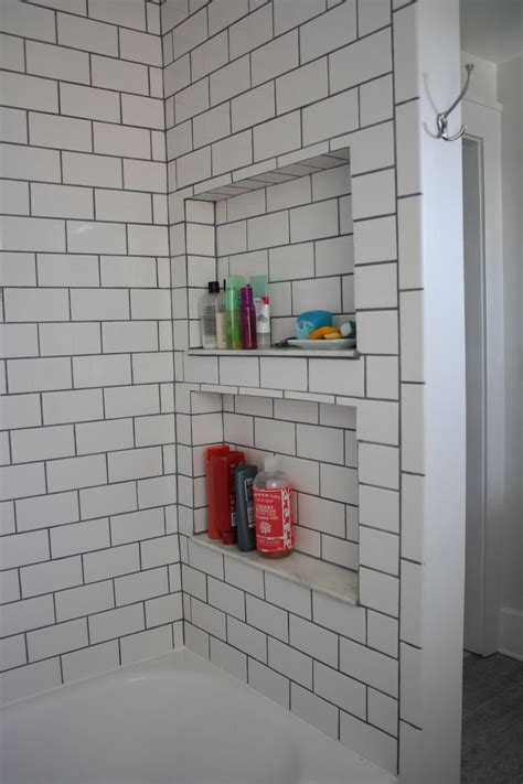 The best in modern lighting. Subway tile shower with black grout and recessed shelves ...