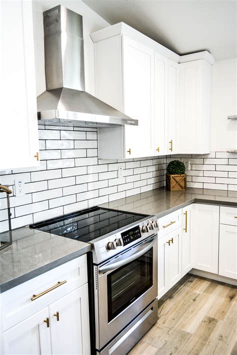 White quartz countertops with white cabinets is an exemplary mix. Design by Beckmann House#beckmann #design #house | Kitchen remodel, White kitchen with gray ...