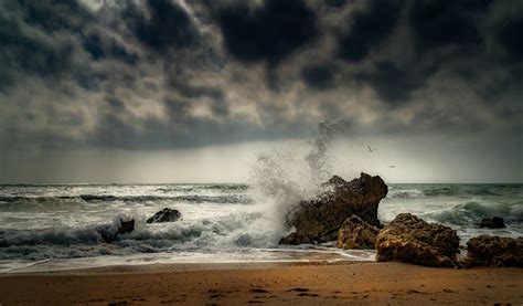 Ocean Waves Crashing On Brown Rock Formation Under Gray Clouds · Free