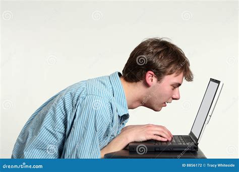 Teen Boy Looking Very Close At Computer Screen Stock Photography
