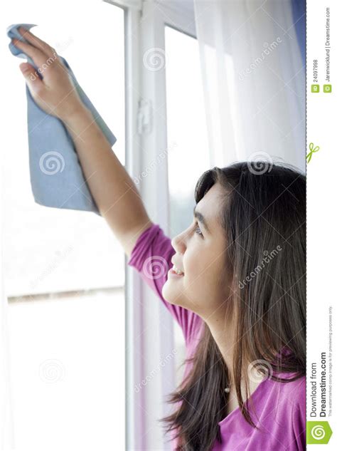 Teen Girl Cleaning Windows Inside Home Royalty Free Stock