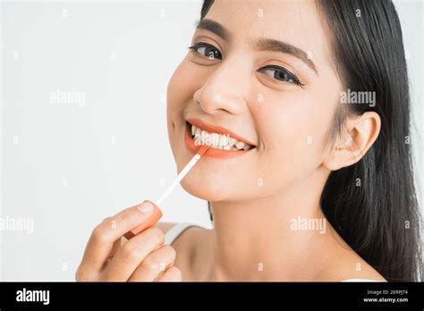 Beauty Face Of Asian Woman Portrait Of Female Applying Lipstick On Her