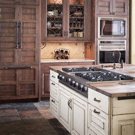 This rustic kitchen features golden brown shaker cabinetry paired with a mint green wall hue and neutral tile backsplash. Colorado Rustic Kitchen Gallery - JM Kitchen Denver