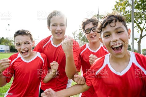 Portrait Of Triumphant Young Male Footballers Stock Photo Download