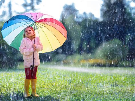 Girl Holding Rainbow Umbrella In Rain Intext1 American Lifestyle Magazine