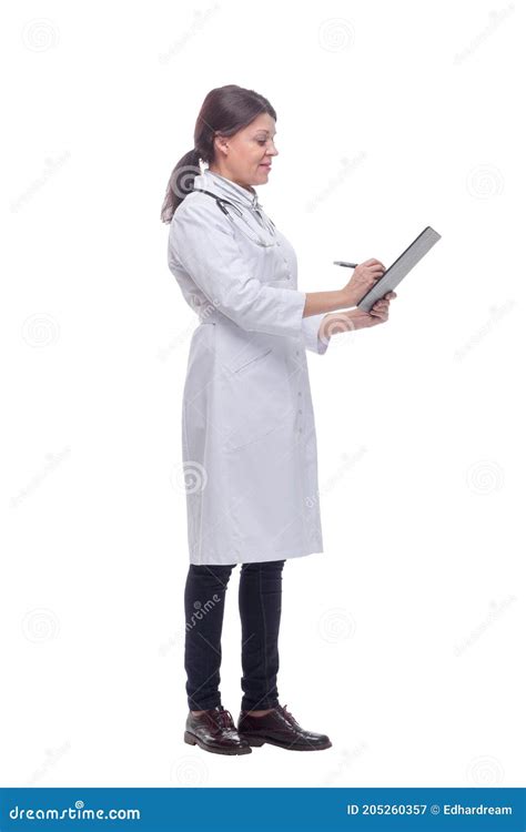 Profile Of Happy Doctor With Stethoscope Writing On Clipboard Stock