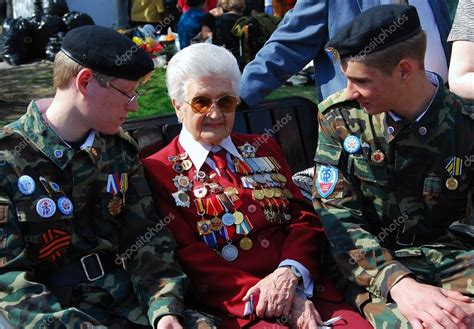 Portrait Of A War Veteran Senior Woman And Two Young Men Stock