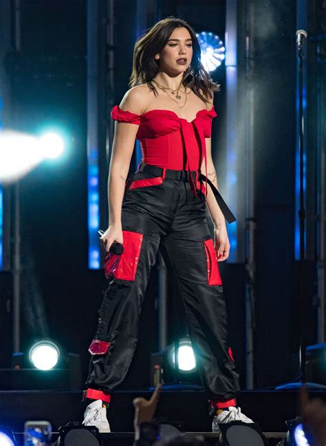 Dua Lipa Wears Ruffled Black Gown With Glimmering Halter Strap To Jingle Ball In New York