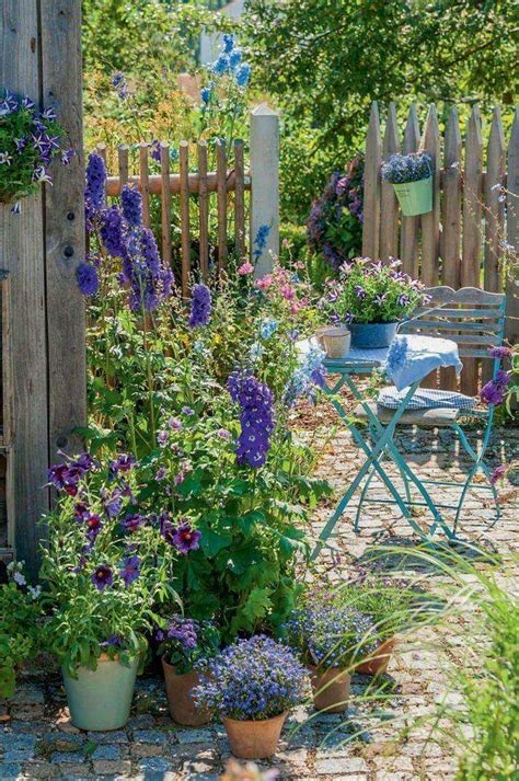 English Cottage Garden With Fence And Table And Chairs
