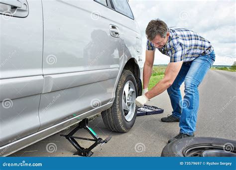 Man Changing A Spare Tire Of Car Stock Image Image Of Road Service