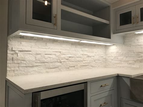 Take the backsplash to the end of the counter, but then you have about 1.5 inches of extra backsplash past where the overhead cupboards end. White Ledgerstone Backsplash - Tile & Stone Techniques