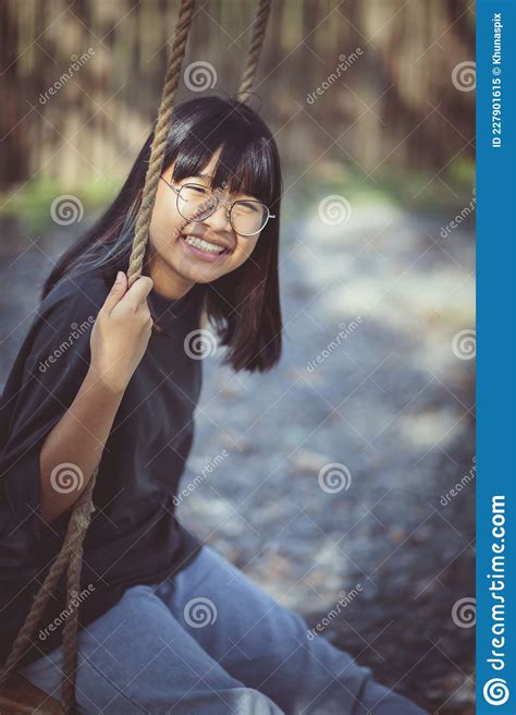 toothy smiling face of asian teenager relaxing in public park stock image image of cheerful