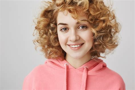 Free Photo Close Up Of Cheerful Dreamy Curly Haired Girl Smiling