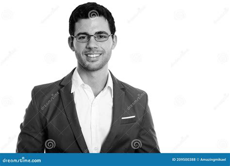 Studio Shot Of Young Happy Hispanic Businessman Smiling While Wearing