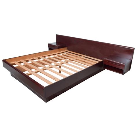 Made from engineered and solid wood, it features a plinth base in a black finish that complements the brown bed frame. Vintage Scandinavian Modern Teak King Platform Bed with Attached Nightstands at 1stDibs