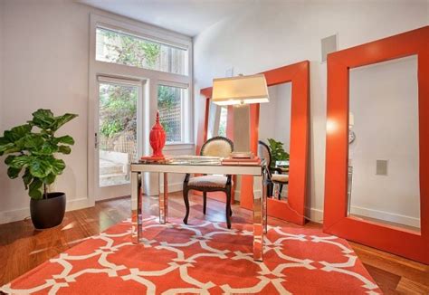 The white frames pictured are the ikea ribba frame and can be purchased online at ikea. Bright orange desk brings color to the home office - Decoist