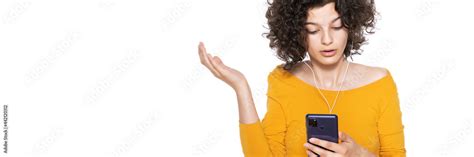 Shocked Angry Young Girl Looking At Her Mobile Phone In Disbelief