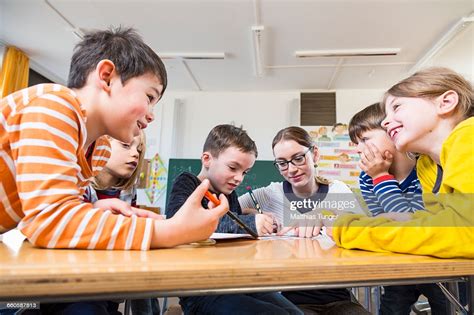 Primary School Children Helping Each Other High Res Stock