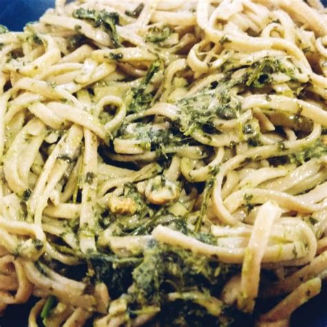 A Blue Bowl Filled With Pasta And Broccoli