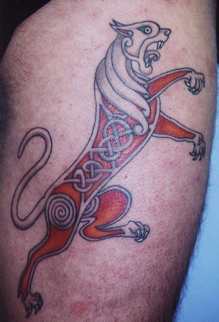 A Tattoo On The Leg Of A Man With A Lion