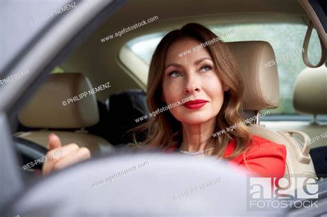 Portrait Of Pensive Mature Woman In Car Stock Photo Picture And