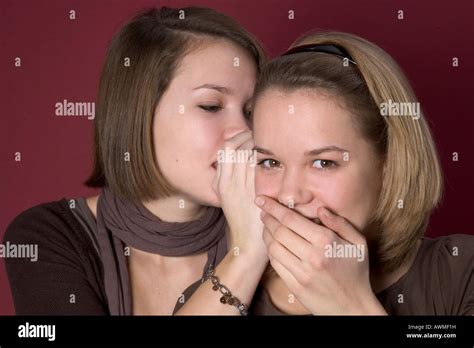 Two Young Girls Whispering To Each Other Hi Res Stock Photography And