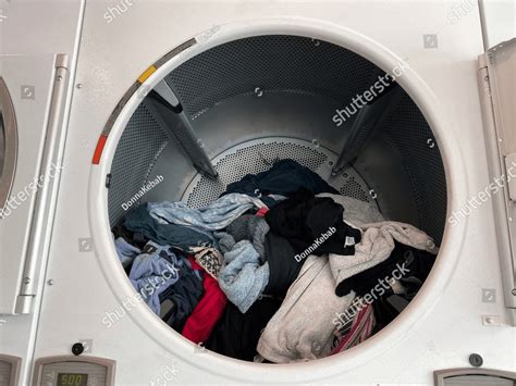 Laundromat Tumble Dryer With The Door Open Showing The Clothing Inside